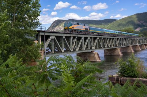 Train on a bridge in Montréal-Québec City by Claude Robidoux