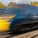 Train at speed through Leyland station in UK (Image RIA)