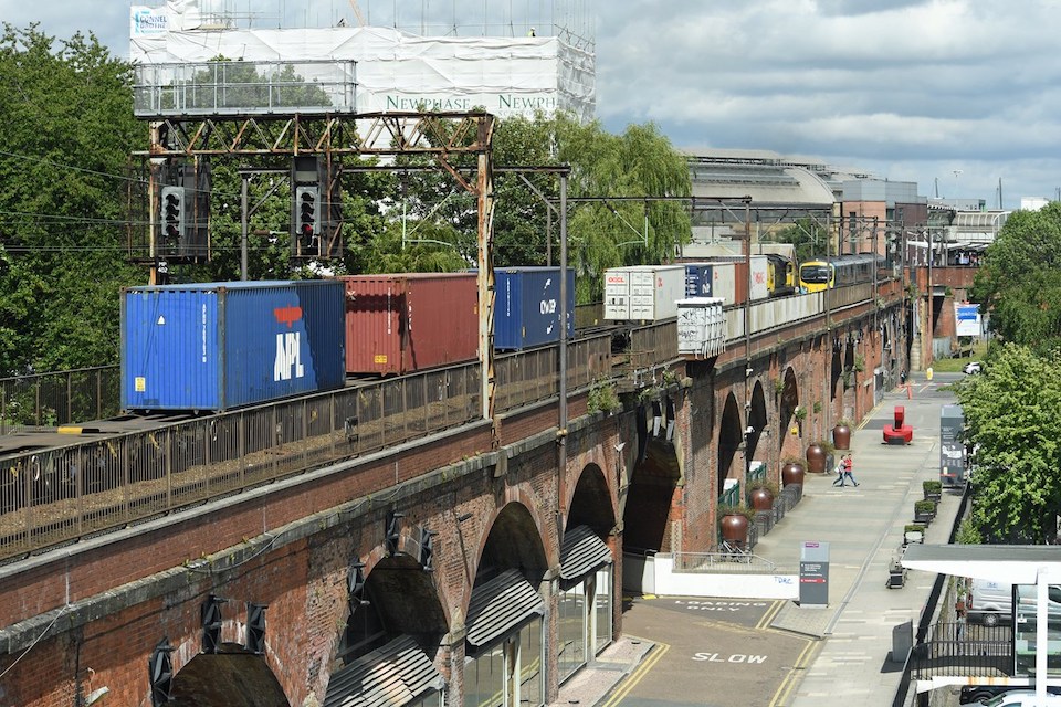 Freight and passenger train passing at Castlefield in Manchester