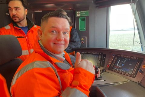 Portrait of Craig Pearson at the controls of a new Metro train in Brno