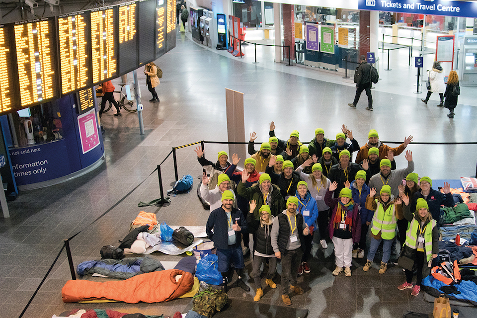 Crowd supporting railway workers sleeping on concourse for charity