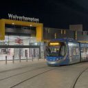 Night time shot of test tram arriving at Wolverhampton railway station