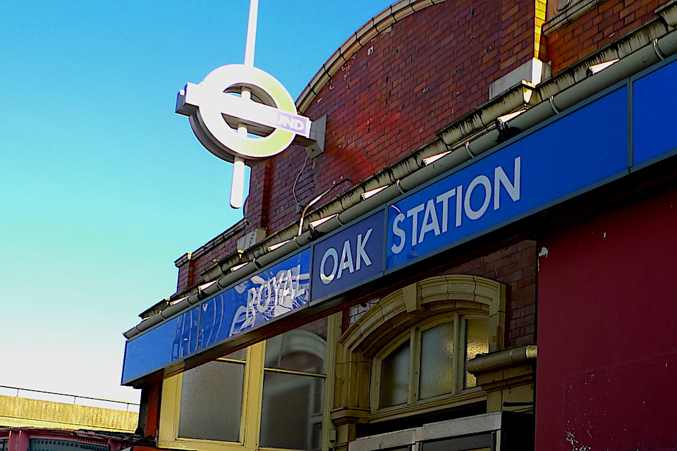 Exterior of Royal Oak Station in London showing the Underground roundel and name plate