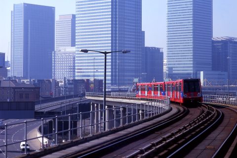 Docklands Light Railway train with Canary Wharf skyscrapers in the background