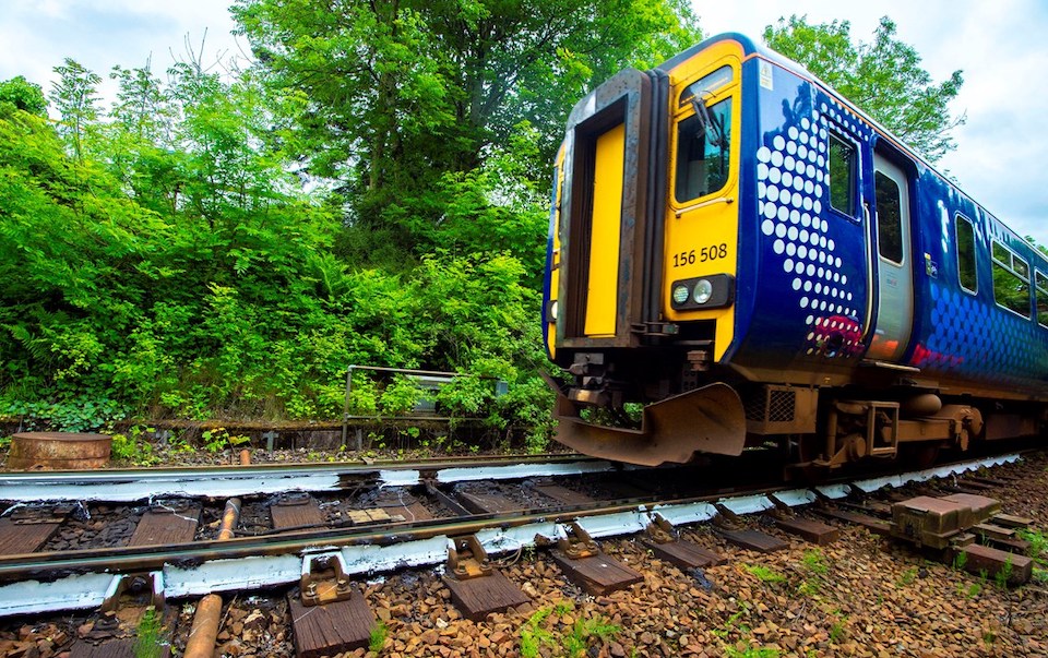 Track level view of a Scottish multiple unit traversing a white painted section of track