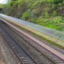 Ghost train speeds through a rural railway setting