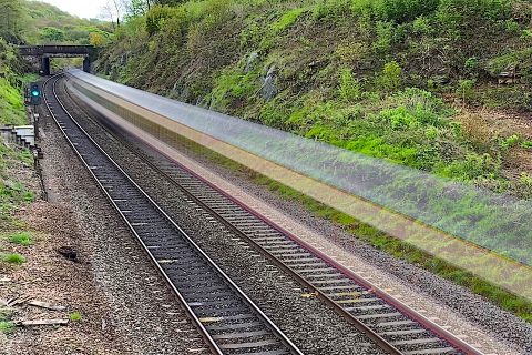 Ghost train speeds through a rural railway setting