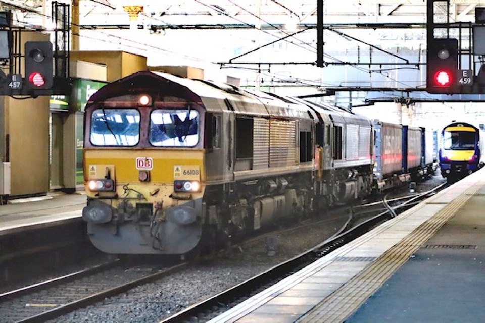 A freight train passes through Edinburgh Waverley station
