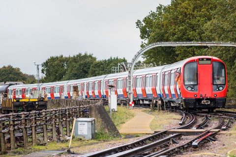 Picture of a London Underground train in the open air negotiating a tight curve