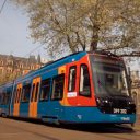 ground level three-quarter shot of Sheffield Supertram tram-train in front of Sheffield Cathedral