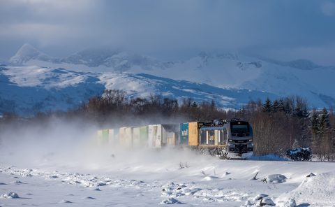 CargoNet Stadler "EuroDual" 159 003 with freight train 5790 Bodø - Alnabru dashes through the snow between Oteråga and Valnesfjord, Norway.