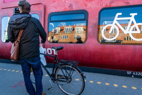 A man takes a bike on a DSB commuter train in Copenhagen, Denmark