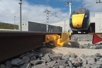 Track level picture of Zonegreen equipment installed on the track at a depot, with an Intercity Express Train approaching slowly