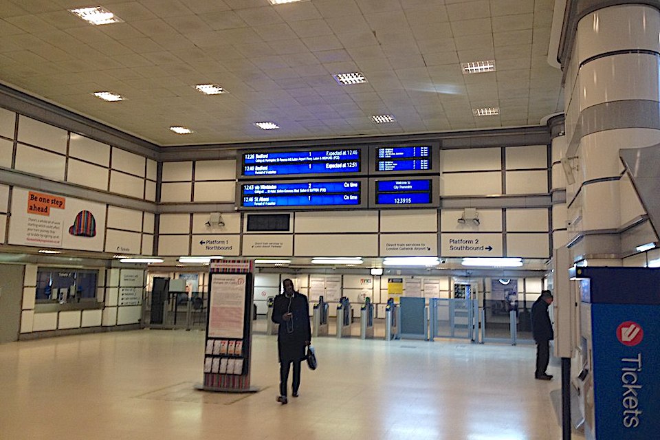 Gneeral view of an almost deserted ticket hall with one passenger