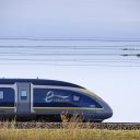 Side on view of Eurostar e320 train at speed through the countryside