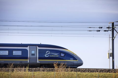 Side on view of Eurostar e320 train at speed through the countryside