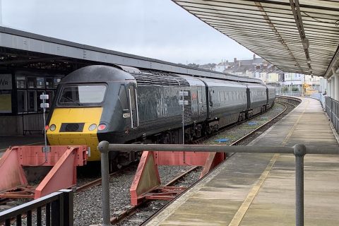 A shot from behind the buffers looking at a GWR HST "Castle Class" train set at Plymouth station