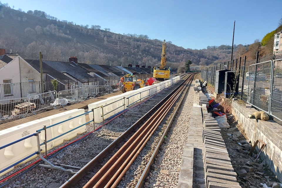 A view of engineering work underway at Llanhilleth station where a second platform is being installed. The scene is largely rural, with a big crane in the background