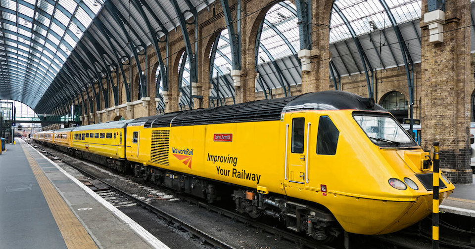 Three quarter view of Network Rail New Measurement Train - an HST set in yellow under a station canopy