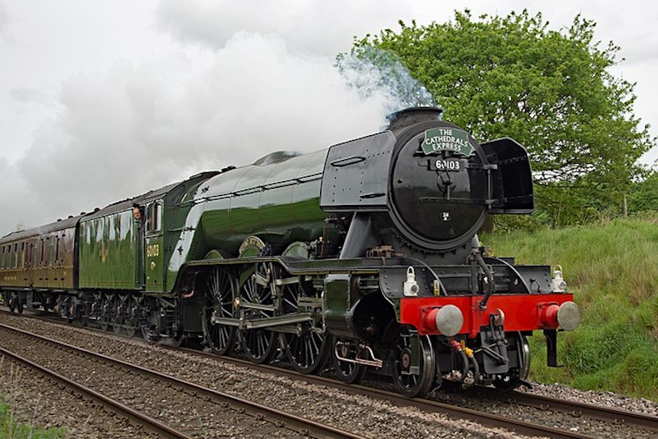Image of Flying Scotsman locomotive in steam pulling a train