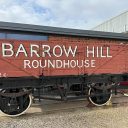 A picture of a historic goods wagon emblazoned with the words "Barrow Hill Roundhouse"