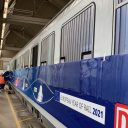 A train is being fitted with FleetShield wrapping