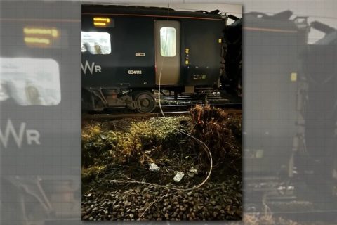 Image of wires down drooped over GWR train at night