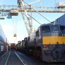 Between two canyons of containers, a pair intermodal trains are being prepared at Waterford's Belview Terminal in Ireland.
