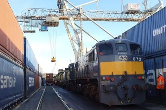 Between two canyons of containers, a pair intermodal trains are being prepared at Waterford's Belview Terminal in Ireland.